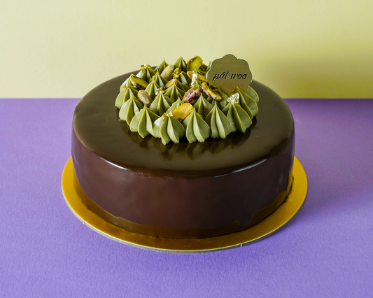 A luxurious cake with dark chocolate glaze garnished with pistachios and pistachio whipped cream. The cake is layered with light pistachio sponge and creamy Sicilian pistachio filing, which are known for their exceptional and rich, nutty flavour. This decadent cake, which is not too sweet, is highly recommended for all the nut lovers and is perfect for the elderly with cravings. 