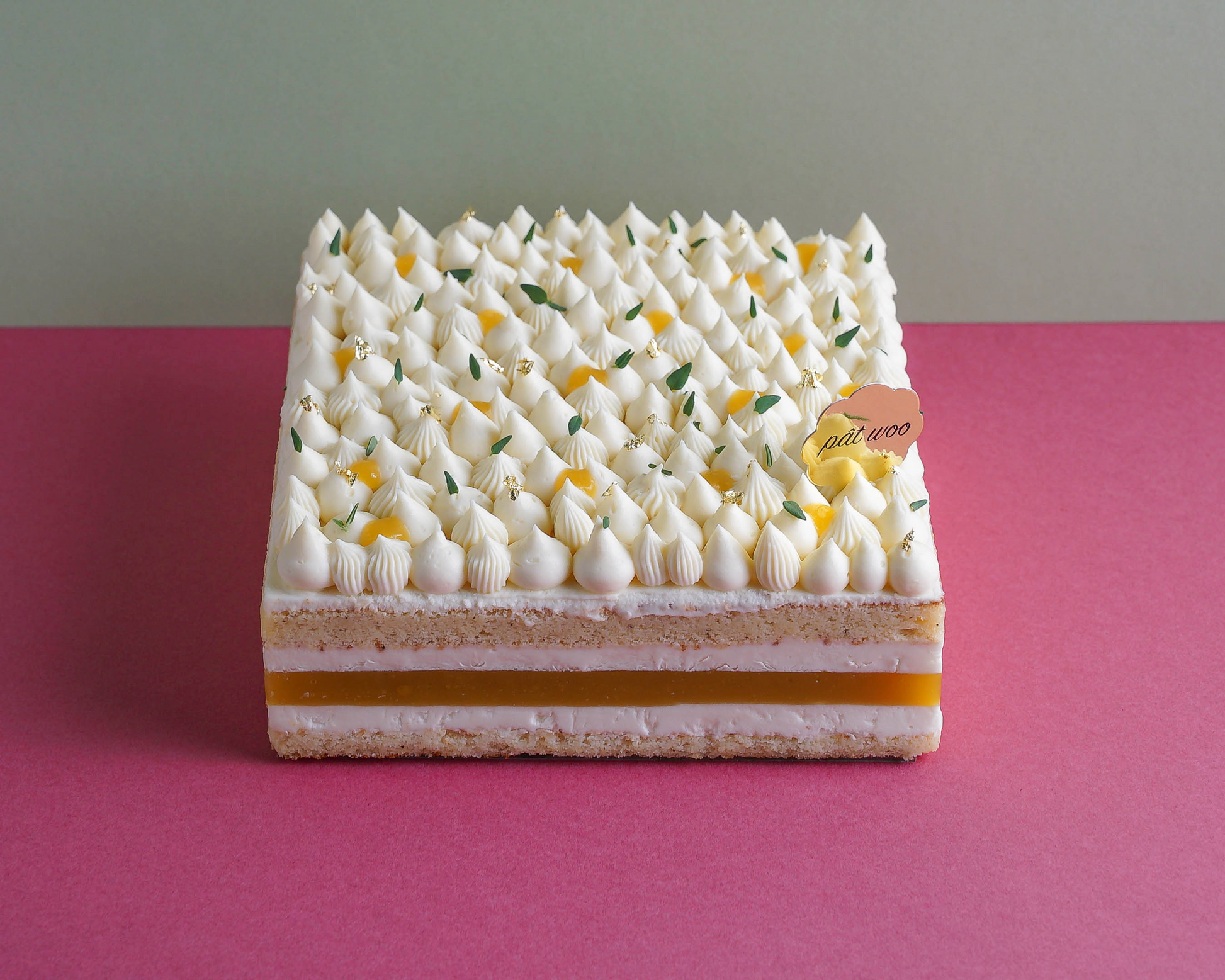 A layered mousse cake topped with whipped cream, mango jelly and gold foil decorations. This tropical delight features layers of light sponge cake infused with Koichi yuzu — known for their aromatic zest and tart flavour, and is also filled with fresh mango jelly. The tanginess of the yuzu complements well with the sweeter flavour of the mango, making this a popular choice among the adults and the elderly. 